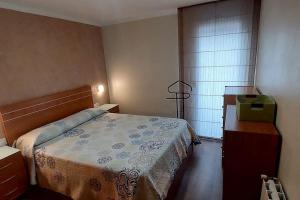 a bedroom with a bed and a dresser and a window at Bravaholidays-831-Fabra-Barcelona in Santa Coloma de Gramanet