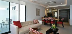a living room with a couch and a dining room at Edificio Poseidon Depto. Vista Lateral al Mar in Manta
