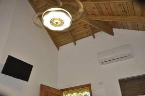 a ceiling fan and a television in a room at Hotel Piedra Marron in Las Terrenas