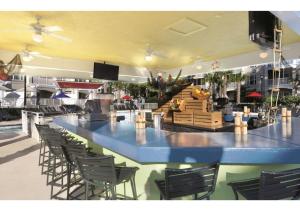 a large bar in a restaurant with chairs at Myrtle Beach Bike Week - Spring Rally - Deluxe Studio Villa Retreat Resort - Special Offer Now! in Myrtle Beach