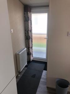 an empty room with a door and a window at Home from Home in Stonham Aspall