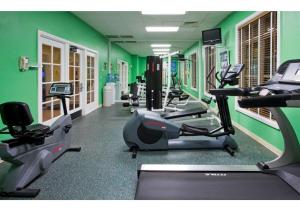 a gym with green walls and tread machines at Myrtle Beach Bike Week - Spring Rally - Deluxe Studio Villa Retreat Resort - Special Offer Now! in Myrtle Beach