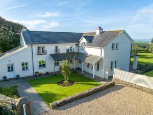 an aerial view of a white house with a yard at Spreacombe Lodge in Woolacombe