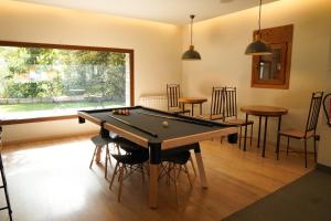 a billiard room with a pool table and chairs at Hotel Els Encantats in Espot