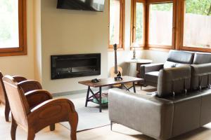 a living room with a couch and a fireplace at Hotel Els Encantats in Espot