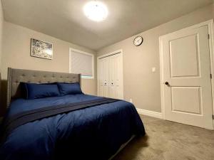 a bedroom with a bed and a clock on the wall at Hillside Villa - Trenton in Trenton