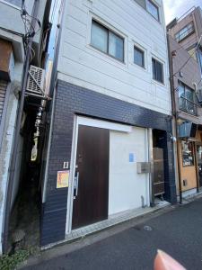 a building with a large door on the side of it at Minowa House - Vacation STAY 61237v in Tokyo