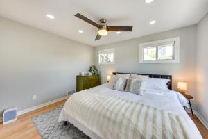 a bedroom with a bed with a ceiling fan at Lakefront Fox Lake Home with Furnished Deck! in Fox Lake