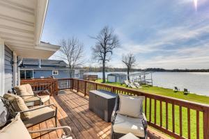 a balcony with chairs and a view of the water at Lakefront Fox Lake Home with Furnished Deck! in Fox Lake