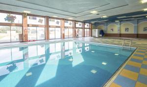 a large swimming pool in a large room at Captivating 2-Bed Caravan in Clacton-on-Sea in Clacton-on-Sea