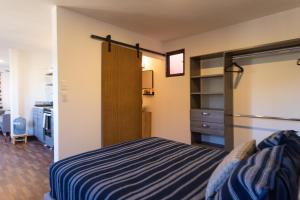 a small bedroom with a bed and a closet at EXPERIENCE in Pescadero