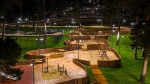 a park at night with a playground with tables and benches at Villa Bakuriani in Bakuriani