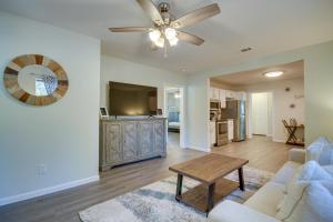 a living room with a couch and a ceiling fan at Gulfport Home with Fire Pit RVandTrailer Parking in Gulfport
