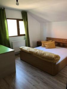 a bedroom with a large bed in a room at Pink House Advance Notice Required in Giarmata