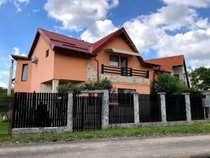 una casa con una valla delante de ella en Pink House Advance Notice Required en Giarmata