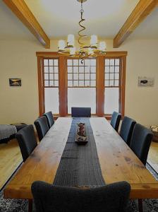 a dining room with a wooden table and chairs at Beautiful 1910 American Craftsman home, close to Bozeman Hot Springs, near Bozeman and Big Sky, Montana. in Gallatin Gateway