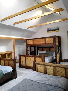 a room with four bunk beds in a room at Beautiful 1910 American Craftsman home, close to Bozeman Hot Springs, near Bozeman and Big Sky, Montana. in Gallatin Gateway