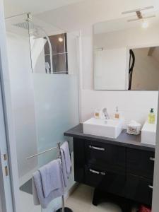 a bathroom with a sink and a mirror at La tour du bonheur in Mantry +26 photos