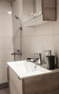 a bathroom with a sink and a shower at Evzoi in Chalkida