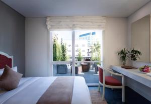 a bedroom with a bed and a large window at Alba Spa Hotel in Hue