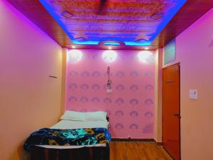 a room with a bed with a purple ceiling at Ayodhya Residency 5 min walking from Ram Janmabhoomi in Ayodhya