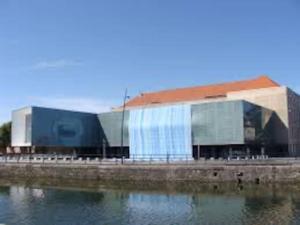 a building next to a body of water at Maison chez graz & virg in Calais