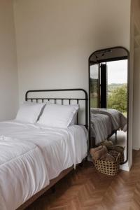 a bedroom with two beds and a mirror at Cabanas Vinsanto in Bento Gonçalves