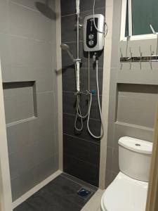 a bathroom with a shower and a toilet at Champs Elysees in Kampar