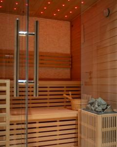 a sauna with wooden walls and wooden floors at Goldberg Apartments Osijek in Osijek