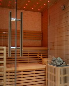 a sauna with wooden walls and wooden floors at Goldberg Apartments Osijek in Osijek +12 photos