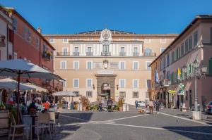 a large building with a clock on top of it at Casa Matta in Castel Gandolfo