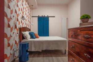 a bedroom with a bed and a blue door at Casa Matta in Castel Gandolfo