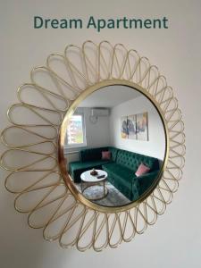 a mirror with a green couch in a living room at Dream Apartment in Lukavica