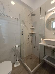a bathroom with a shower and a toilet and a sink at Cyclades Studios in Parikia