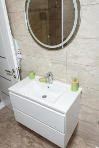 a bathroom with a white sink and a mirror at Apartment Marija in Pale