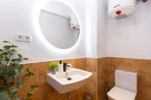 a bathroom with a white sink and a mirror at Duplex with terrace near Bcn in Terrassa