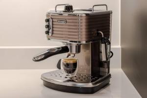 a coffee maker sitting on a counter with a cup of coffee at The Ladywell in Lewisham in London