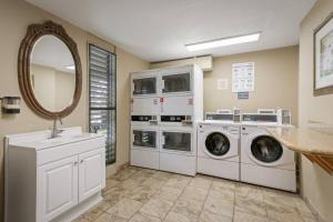 a laundry room with two washing machines and a mirror at Kona Bali Kai Unit 362 Partial Ocean View Studio in Kailua-Kona