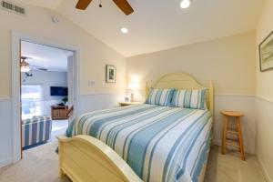 a bedroom with a bed with a blue and white comforter at Waterfront Topping Vacation Home with Boat Dock! in Topping