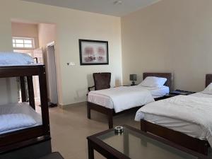 a hotel room with two beds and a table at Kundmalir Gold Coast Beach Resort 
