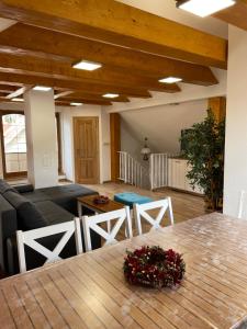 a living room with a wooden table and chairs at Chalupa pod Tatrami in Liptovská Teplička