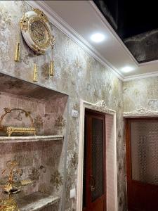 um quarto com um espelho e um relógio na parede em «Gulnara» Luxurious house for rent as a whole new 5 rooms and a yard. em Samarkand
