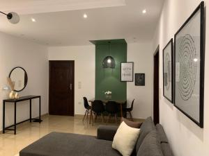 a living room with a couch and a table at A Cozy Apt in Obour City in ‘Ezbet el-Insha