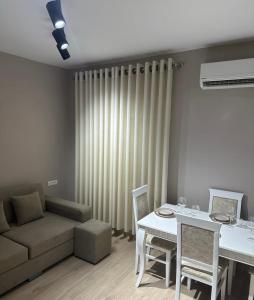 a living room with a couch and a table at 4SeasonsGea,Urban Lifestyle Apartment,Tirana in Tirana