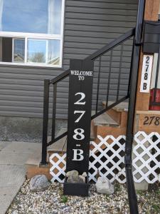 a welcome sign in front of a house at Winnipeg Place to Stay in Winnipeg