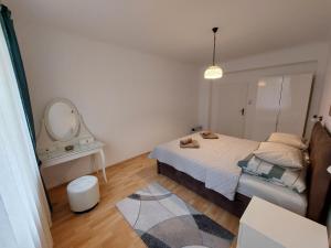 a small bedroom with a bed and a mirror at 3-rooms apartment for up to 4 persons near to Prater in Vienna