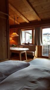 a bedroom with a bed and a table in a room at Appartement Seebacher in Hochfilzen