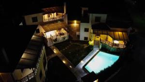 an overhead view of a building with a swimming pool at night at Villa Eridos in Káto Lekhónia