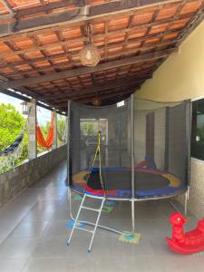a room with a tent with a trampoline at Pousada jardim imbassay in Mata de Sao Joao
