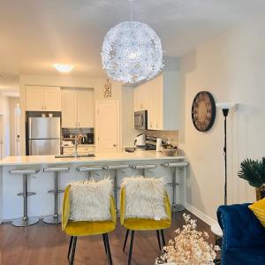 a kitchen with two yellow chairs and a counter at Beautiful Nest By The Airport in Ottawa